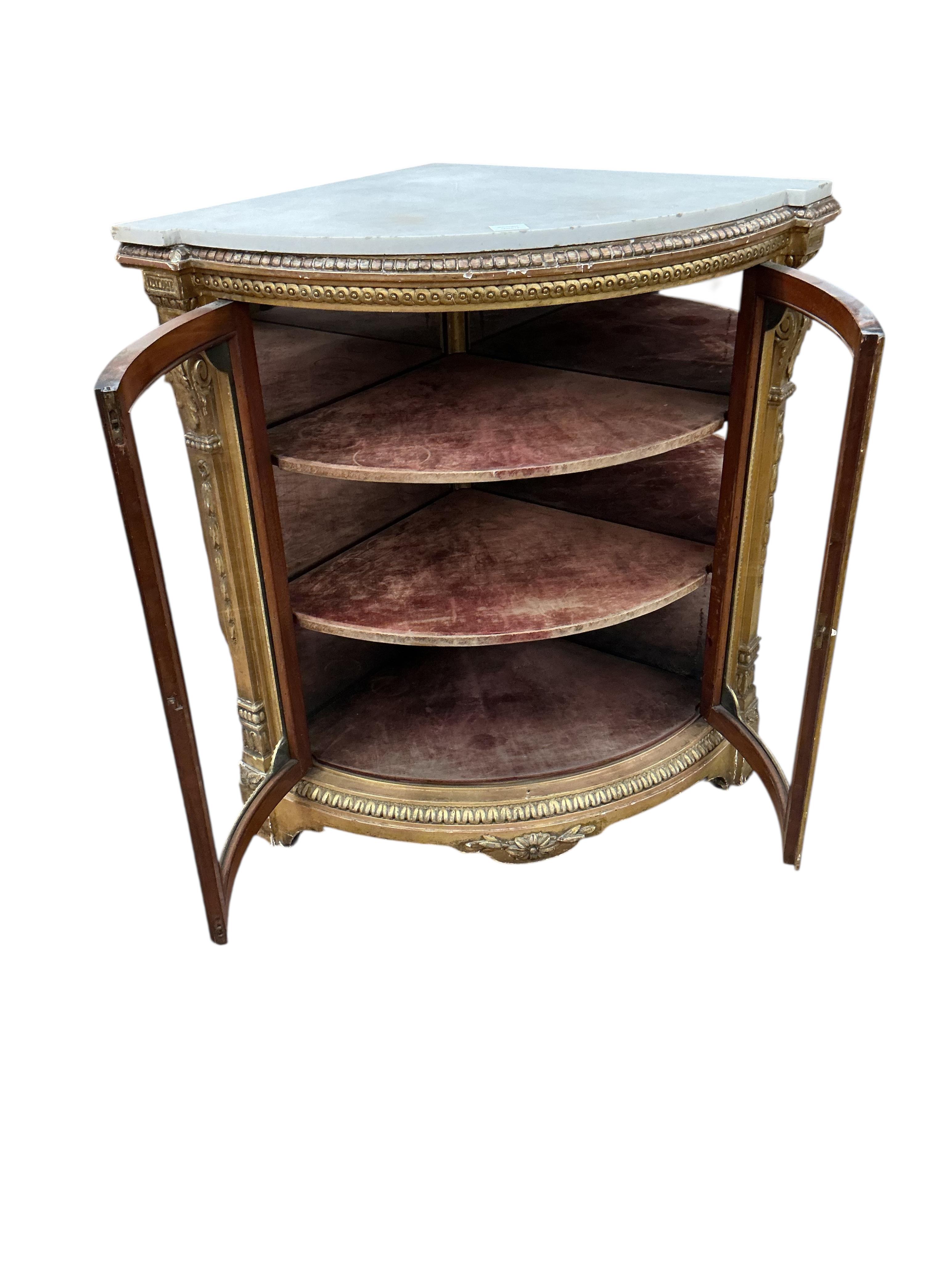 A Louis XVI style giltwood and composition marble topped corner cabinet, width 94cm, depth 69cm, height 95cm